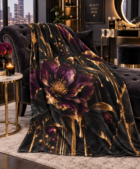 Vesper Bloom velveteen plush blanket featuring oversized deep plum and black flowers with gilded leaves, gold drips and dark marble-inspired accents.
