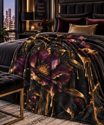 Vesper Bloom velveteen plush blanket featuring oversized deep plum and black flowers with gilded leaves, gold drips and dark marble-inspired accents.